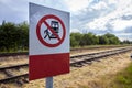 Warning Sign Prohibiting Access to Railway Tracks Under the Bright Sunlight Royalty Free Stock Photo