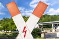 Warning sign before the rail crossing, in the shape of a cross with a symbol of lightning. Royalty Free Stock Photo