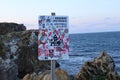 Warning sign on rocky coastal cliffs Royalty Free Stock Photo