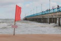 Warning sign of a red flag at a beautiful beach with a blue sky Baltic sea, Swimming are forbidden. Palanga, Lithuania Royalty Free Stock Photo