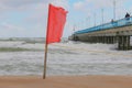 Warning sign of a red flag at a beautiful beach. Swimming are forbidden Royalty Free Stock Photo