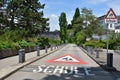 Warning sign on a road and vertical traffic sign on way to school in German language in Switzerland. Royalty Free Stock Photo