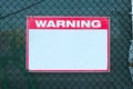 Warning Sign safety caution with blank white message at construction site grid boundary. Royalty Free Stock Photo