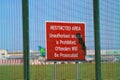 Warning sign on security fence