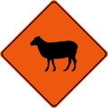 Warning sign with sheeps on road Royalty Free Stock Photo