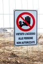 Warning sign on the shoreline in Follonica, Italy Royalty Free Stock Photo