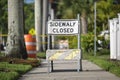 Warning sign that sidewalk is closed at street construction site. Utility work ahead Royalty Free Stock Photo