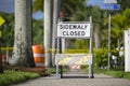 Warning sign that sidewalk is closed at street construction site. Utility work ahead Royalty Free Stock Photo