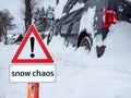 Warning sign `snow chaos` on the road