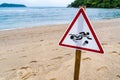 Warning sign for swimming in the sea, beware of jellyfish, placed on the beach