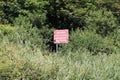 A warning sign to keep away from the cliff at Axmouth on the Jurassic coast. Rain and erosion causes frequent rock falls Royalty Free Stock Photo