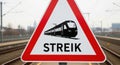 Warning sign for train strike ahead on railway tracks with blurred background Royalty Free Stock Photo