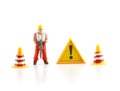 Warning sign under construction with miniature figure labo