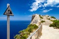 Warning sign at vantage point with view Mirador Es Colomer on punta nau at cap formentor majorca mallorca. Balearic islands