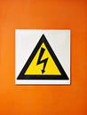 Warning, sign and voltage with triangle or symbol for alert, precaution or safety at warehouse or factory. Hazard poster