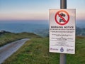 A warning sign on a walking trail in the Derbyshire countryside