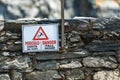 Warning sign of fall hazard in English and Italian - Vernazza Italy Royalty Free Stock Photo