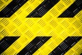 Warning sign with yellow and black stripes painted on steel checker plate or diamond plate hazard danger warning background Royalty Free Stock Photo