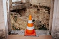 Warning signal cone with a destroyed building Royalty Free Stock Photo