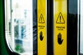 Warning Signs with Hands Symbol on Doors of Indonesia Commuter Train Royalty Free Stock Photo