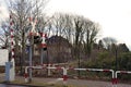 Warning signs and lamps with barrier at railroad crossing Royalty Free Stock Photo