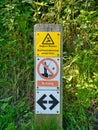 Warning signs on the Leeds to Liverpool Canal in Lancashire, UK - the signs prohibit fishing due to overhead power lines