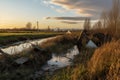 warning signs posted near a damaged levee area