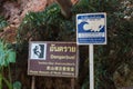 Warning signs about rock climbing and tsunami, west of Krabi, Thailand.