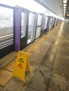 The warning signs wet floor on the sky train station to remind people to walk safely Royalty Free Stock Photo