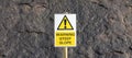 Steep slope sign against stone background