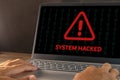 Warning of a system hacked concept. Hacker or cyber criminal with laptop stealing user personal data