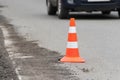 Warning traffic road cone set on asphalt street road during road repairing, asphalt pavement works on automobile highway Royalty Free Stock Photo