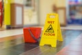 Warning yellow plastic sign of wet floor