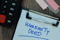 Warranty Deed write on a paperwork isolated on Wooden Table. Business or Financial Concept Royalty Free Stock Photo