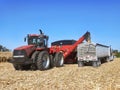 CASE IH 470 Steiger tractor pulling a Brent Avalanche 1396 grain cart as it unloades into a transport truck trailer