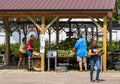 Warren, Pennsylvania, USA August 14, 2022 Men and women at a roadside corn stand