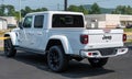Warren, Pennsylvania, USA June 18, 2023 A white Jeep Gladiator 4x4 SUV for sale at a dealership
