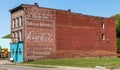 Warren, Pennsylvania, USA May 15, 2023 An older, three story brick building with faded advertising on its side and a closed bar