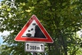 Warring traffic sign in red triangle, falling rocks from the right, on the secondary road Royalty Free Stock Photo