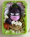 The warrior is made of rice. Kyaraben, bento. The fighter is dressed in a mask and holds a weapon in his fist.