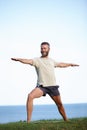 Warrior in nature. Full length shot of a handsome mature man doing yoga outdoors. Royalty Free Stock Photo