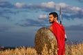 Warrior in red cloak holding sword and iron weapon. Royalty Free Stock Photo