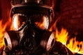 Warrior soldier in gas mask in fire closeup