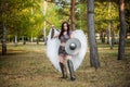 Warrior woman in chain mail with steel bracers and greaves and wings behind her back, holding a spear and a shield.