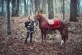 Warrior woman with her brown horse into the woods - Beautiful Scandinavian viking girl