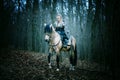 Warrior Woman on a horse in the woods. Scandinavian viking