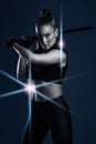 Warrior, woman and sword portrait to fight in studio for action on dark background. Strong female model, assassin or