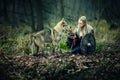 Viking Princess in traditional armour alone in woods with wolf