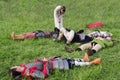 Warriors in medieval armor, resting on the grass