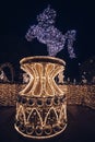 20.12.2021 - Warsaw. The capital of Poland during Christmas holidays. Fountain made of Christmas lights. Blue horse on a golden